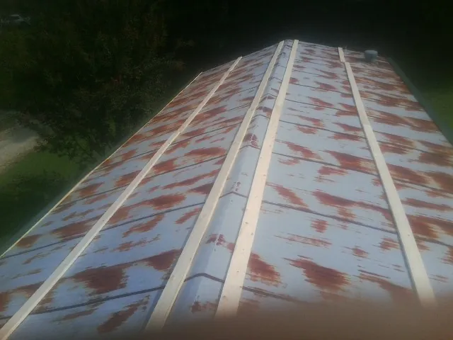 Rusted metal roof panels with new wood purlins before replacement — Storm Damage Roof Repair in Locust Dale by Roofing Brothers