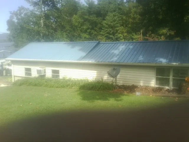 Blue metal roof running the length of a single story home in Locust Dale