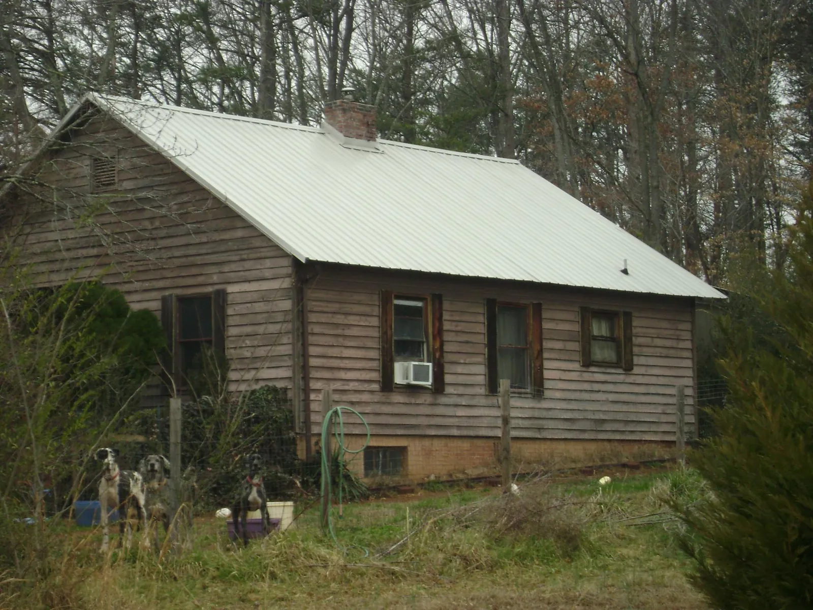 White metal roof on an old wood sided farmhouse, from a Metal Roof Installation job in Locust Dale